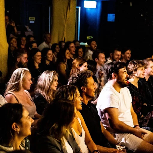 A laughing crowd watching a show in The Den at The Chippo Hotel