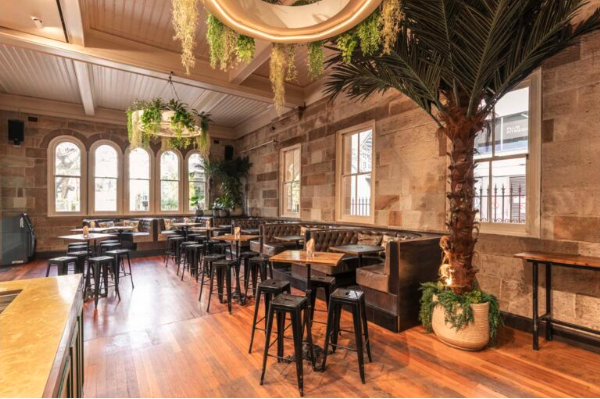 The Lounge Bar interior at The Greenwood Hotel — sandstone walls, leather booths and high tables