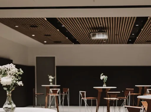 The community room at Harbord Diggers set with high tables and stools, a ceiling projector above